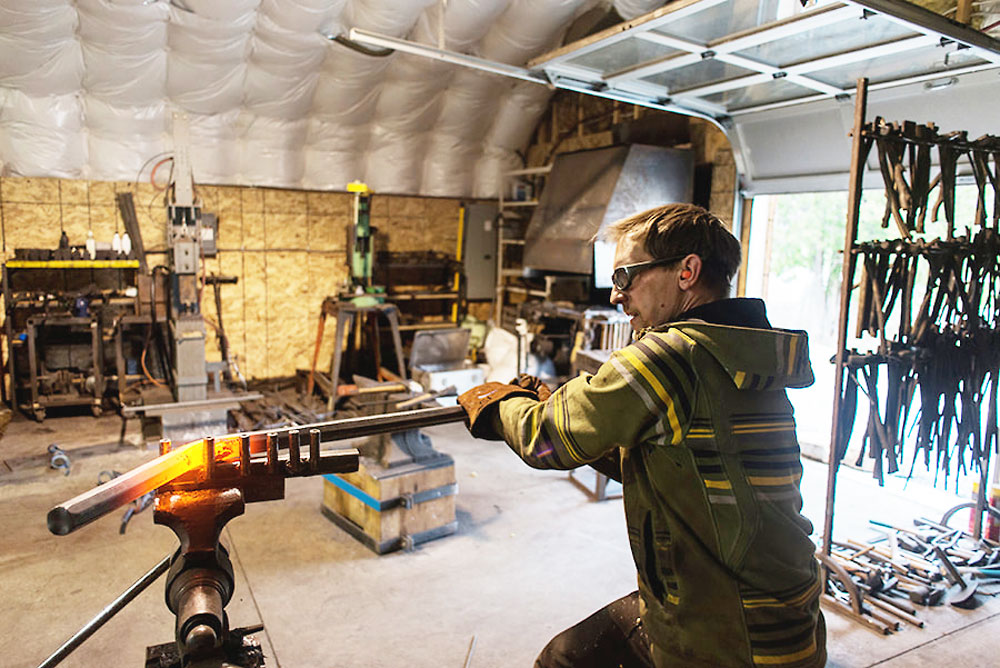 Blacksmith Stephen Duerst, bends heated metal.