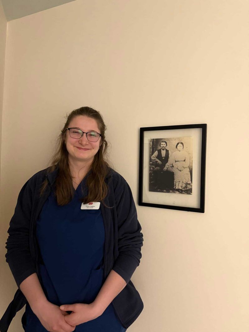 Nursing Student Poses With Ancestral Photo After Hyper Local Practicum