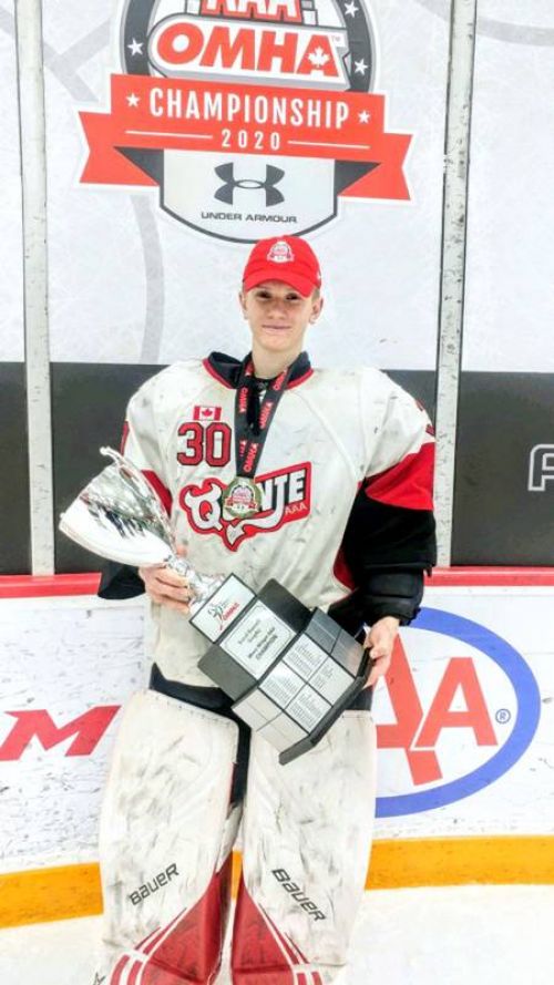 Corbin Votary holdingthe OMHA trophy in hte midget division