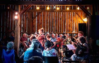 “Members of Night Sun play together for the first time in 25 years to a full house at Leopard Frog Barn.”