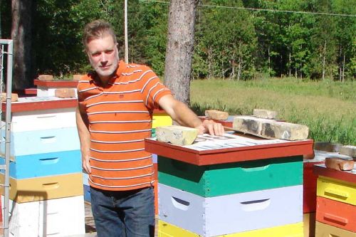 Marcus Saunders with his colorful hives