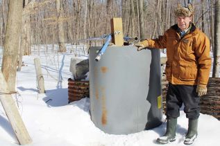 Gary Gorr at one of his main lines in his sugar bush just south of Harrowsmith. “Straight, tight and downhill,” he said. Photo/Craig Bakay