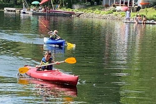 Hudson Campbell moves into second place in his division while kayaking on his way to first in the nine-and-under age category