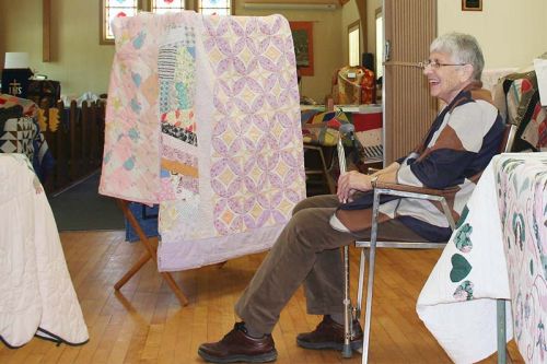 June Hughes takes a break from welcoming visitors to the quilt display at United Church in Arden. Photo/Craig Bakay