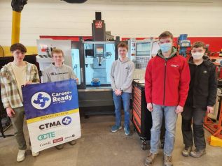 Zack, Reid, Franklin, Makenzie, Austin standing with the CNC machine.