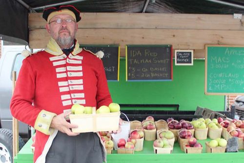 Mike Janssens of Janssens Fresh Produce sports a British redcoat from the Napoleonic era while promoting his antique apple varieties. Photo/Craig Bakay