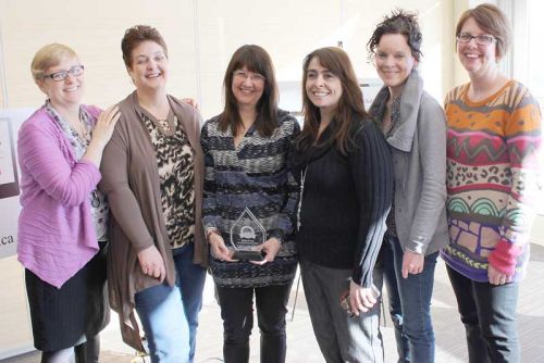 Maribeth Scott (3rd from left) at the awards ceremony with Jan MacPpherson and Marcie Asselstine from NFCS and some of their colleagues from Family and Children's Services at the award ceremony.