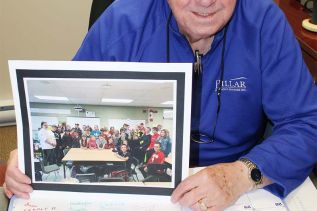 Marcel Giroux with the card of appreciation students in the slow cooker. Photo/Craig Bakay