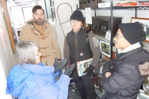 Sally Angle shares her knowledge of the K&P Trail and railway at the Sharbot Lake caboose with Noah Scheinman, Adam Biehler and Allan Poon