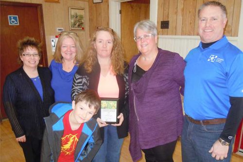 L-r, CCS reps Debbie Drawbridge, April McCann, Barb Revelle and Doug Kane presented Lesley Merrigan (centre with her son Braidey) with the CCS's Impact in Community Leadership award