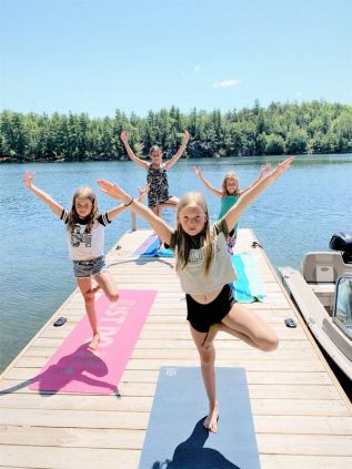 The Porcupine Island Crew – Emily Youngman, 8, Emily Hunter, 10, Claire Youngman, 10, Louisa Hunter, 6, and Mia Tomlinson, 11, (not pictured in the yoga photo) – have begun their training for the first annual Buck Lake Kids Triathlon. They’ve all been in each other’s social bubbles for several weeks now and so can safely train closely and compete as a team.