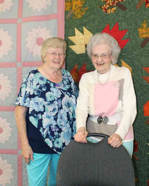 Peggy Newport and Irma Bertrim are both long-time members of the Perth Road Crafters, with Irma edging out Peggy in terms of longevity. The quilt on the left contains the names of many former members