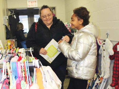 Adi Sweet Okechukwu gets mom Ruth Sweet’s approval on some treasure she found at the Hartington Community Caring Christmas Open House Sunday in Hartington. Photo/Craig Bakay