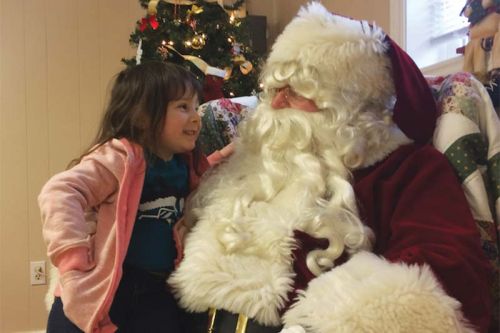 Olivia Webster visting with Santa at the S&A Club