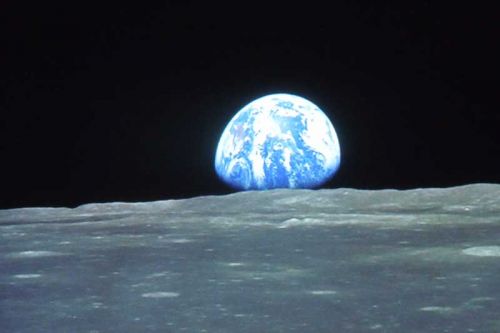 A slide shows earth as seen from the moon during Terence Dickinson's presentation “A Tour of the Universe” at Prince Charles PS  